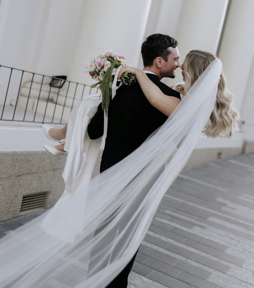Bride and groom embracing on a city street