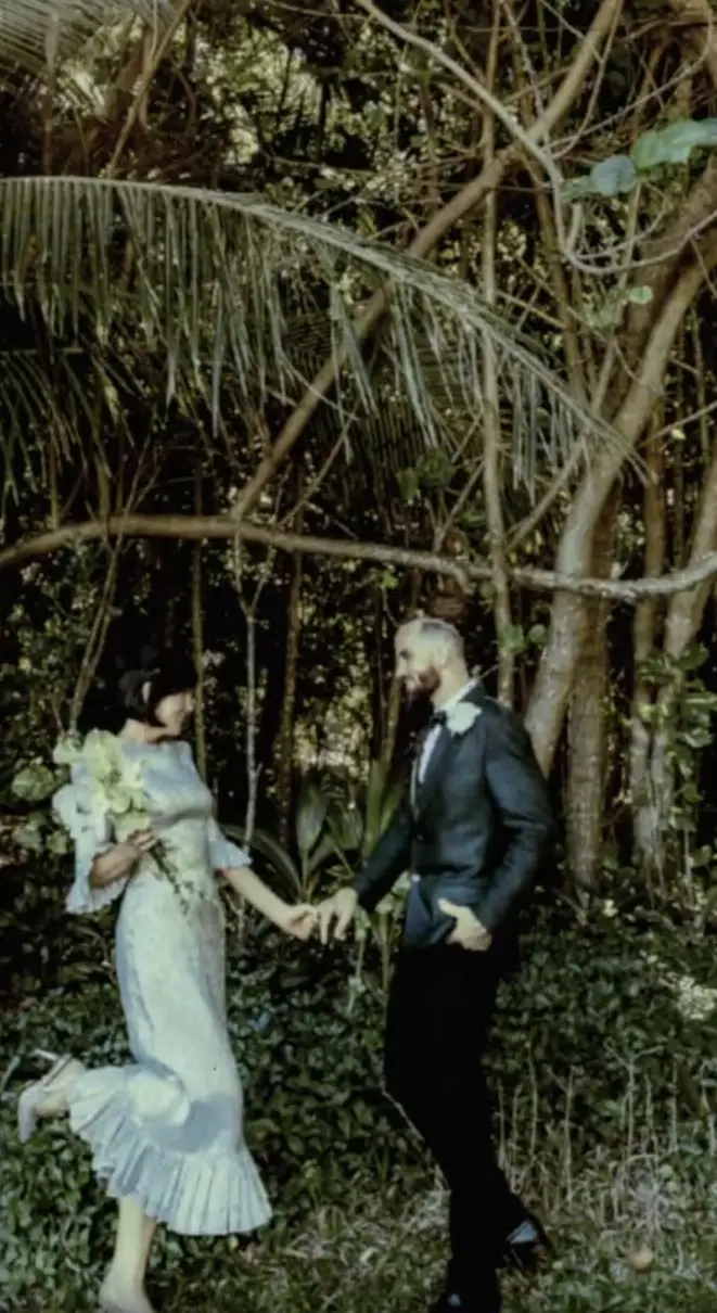 Bride and groom walking hand in hand, golden hour
